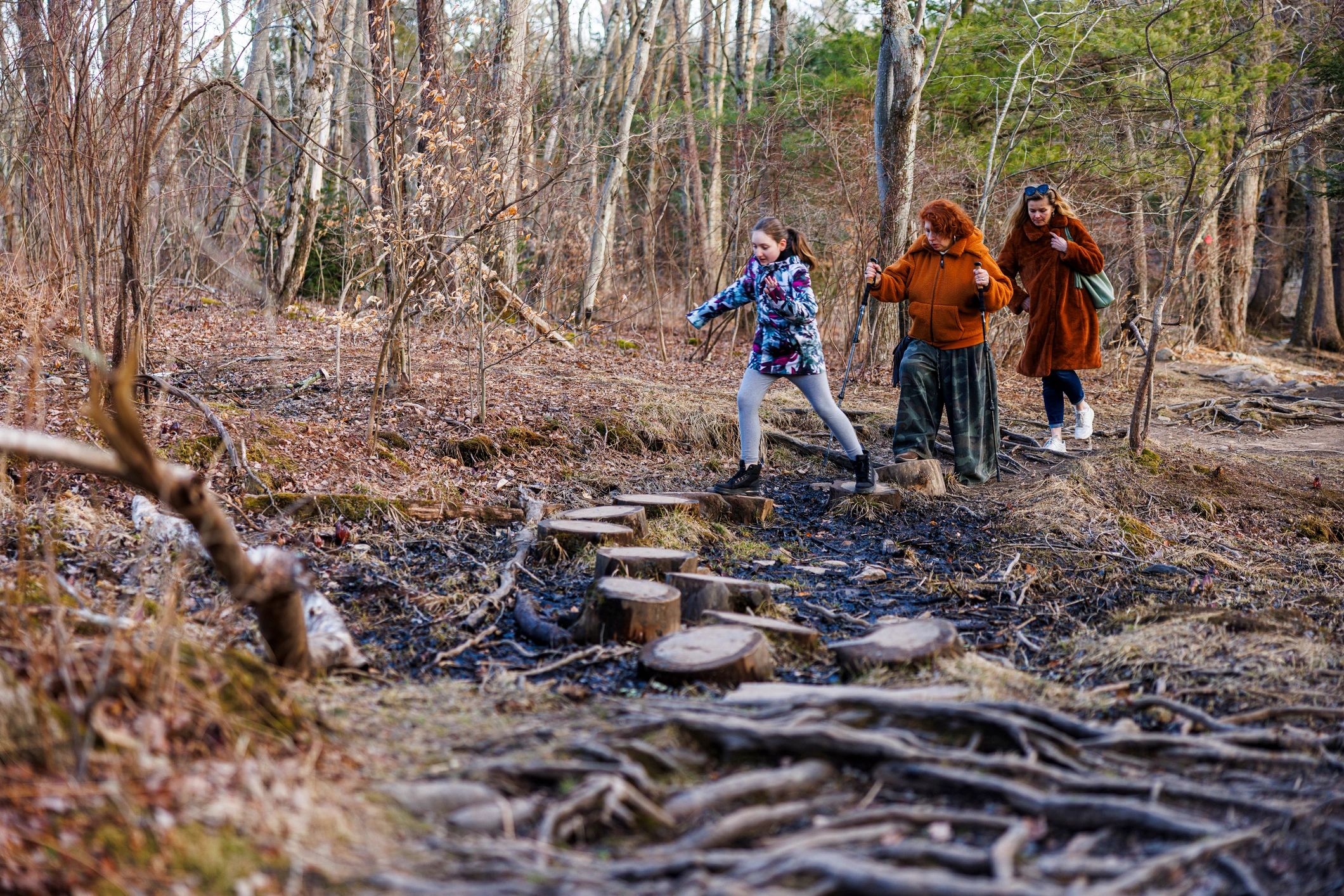 Young person walking along a woodland learning trail